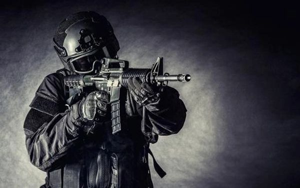 Spec Ops Police Officer Swat in Black Uniform and Face Mask