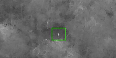 A white vertical object in a gray textured background.