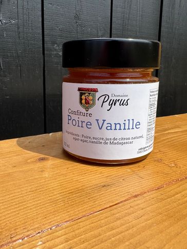 Jar of Domaine Pyrus pear vanilla jam on wooden surface.