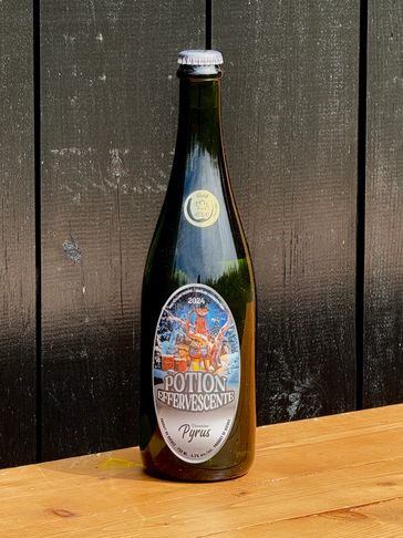 A bottle of Potion Effervescente Pyrus on a wooden table.