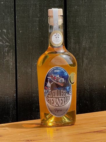 A bottle of L'Veillee Eternelle Pyrius placed on a wooden surface against a dark background.