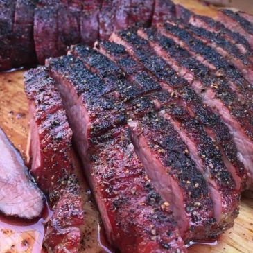 Sliced, perfectly grilled smoked brisket with pepper crust.