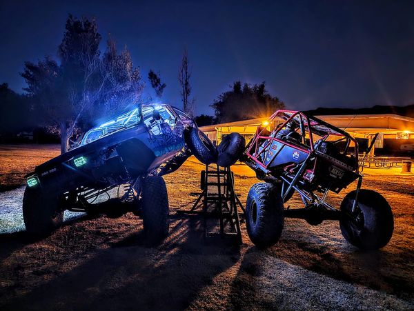 Jeep and rock crawler buggy flexing on ramp, LED lights