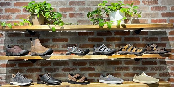 Men's Shoe Wall with Keen, Hoka, Olukai, Naot, and Merrell shoes