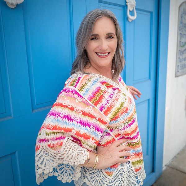 Sandra Coiffman in front of a blue door.