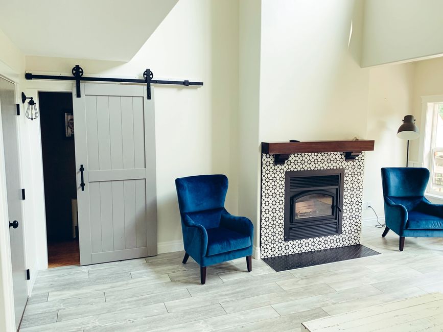 Paint job in living room with grey accents and white walls.