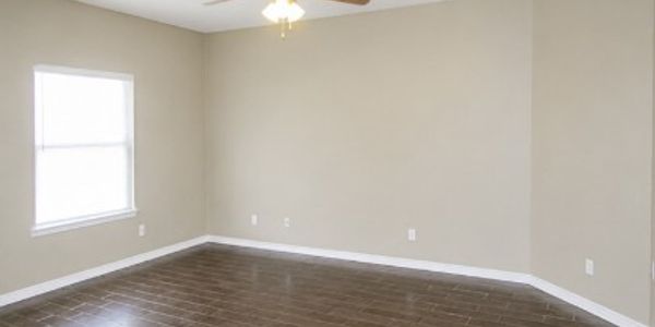 Empty room with beige walls and tiled floor.
