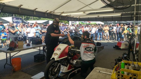 Seattle Top Fuel Harley Motorcycle pit warm-up with fans.