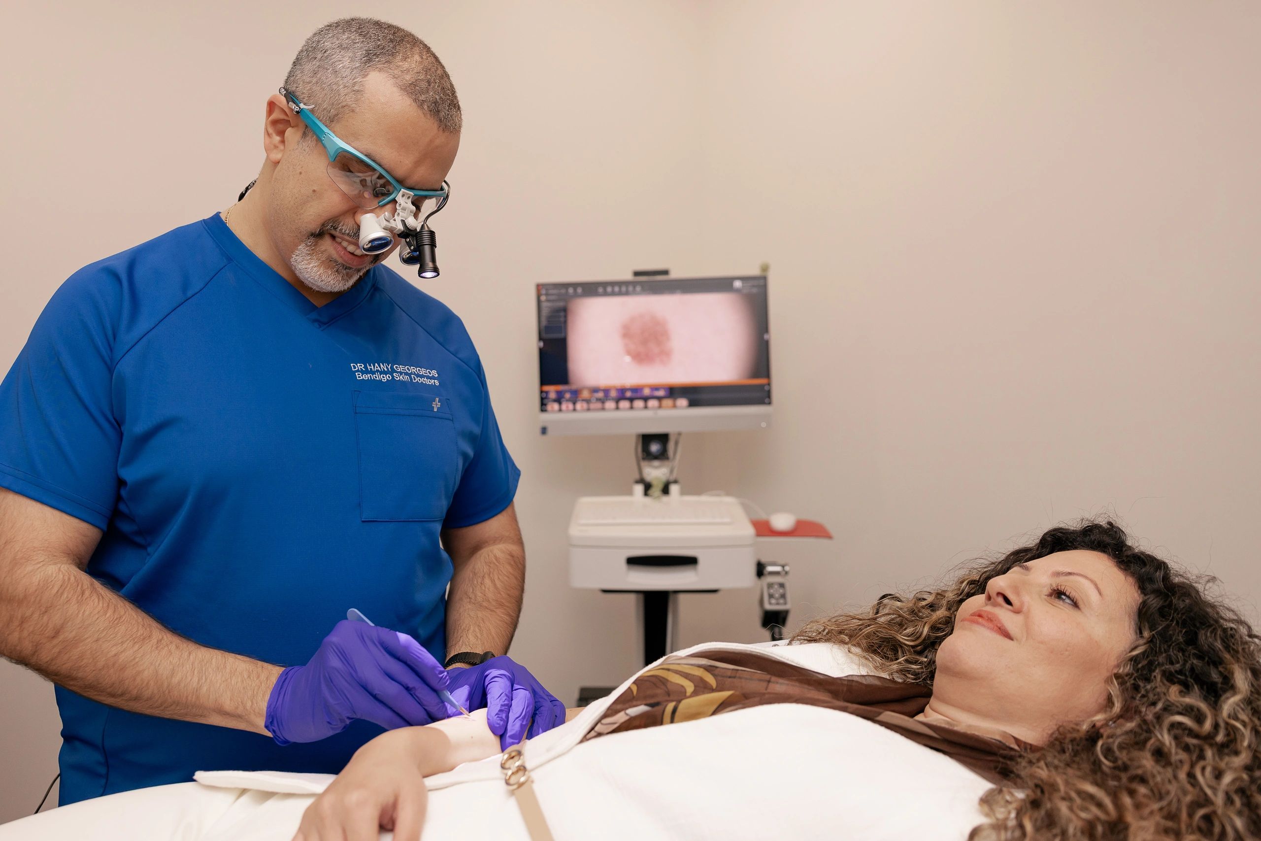 Doctor performing skin treatment on a patient.