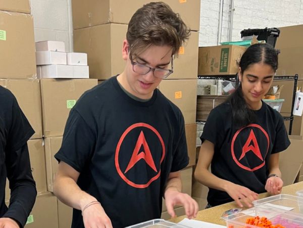 Two people organizing items in a warehouse.
