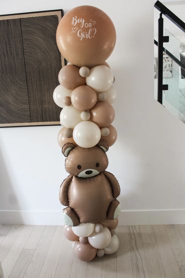 Balloon arrangement with a teddy bear and 'Boy or Girl?' text for a gender reveal.