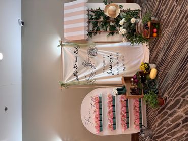 Elegant floral and fruit display for Jessica's baby shower with personalized banner.
