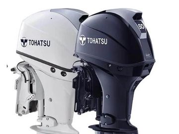 Two Tohatsu outboard boat motors in black and white.