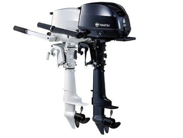 Two Tohatsu outboard boat motors, one white and one black.