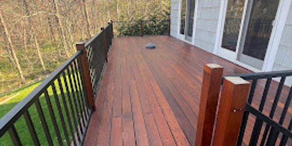 Empty wooden deck with metal railings.