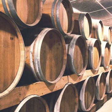 Rows of stacked barrels in a barn