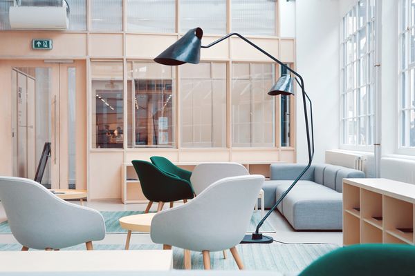 The light shines through the tall windows in this modern interior designed home into a reading room.