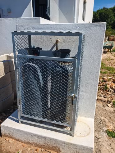 Metal cage with two large gas cylinders.