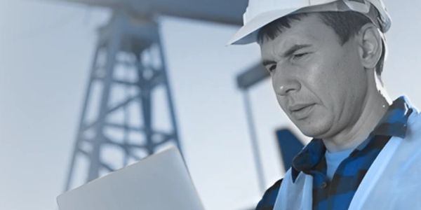 Engineer reviewing plans at an industrial site.