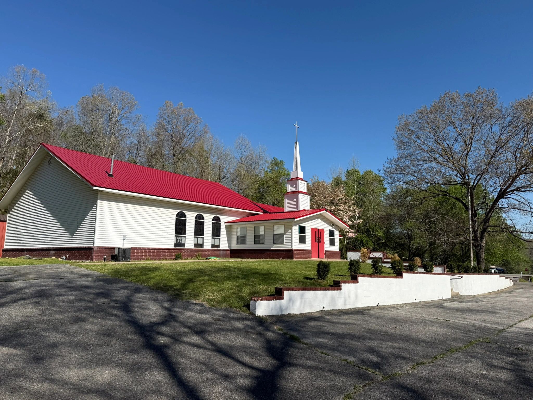 Corpus Christi Anglican Church — white church with red roof under clear blue sky
