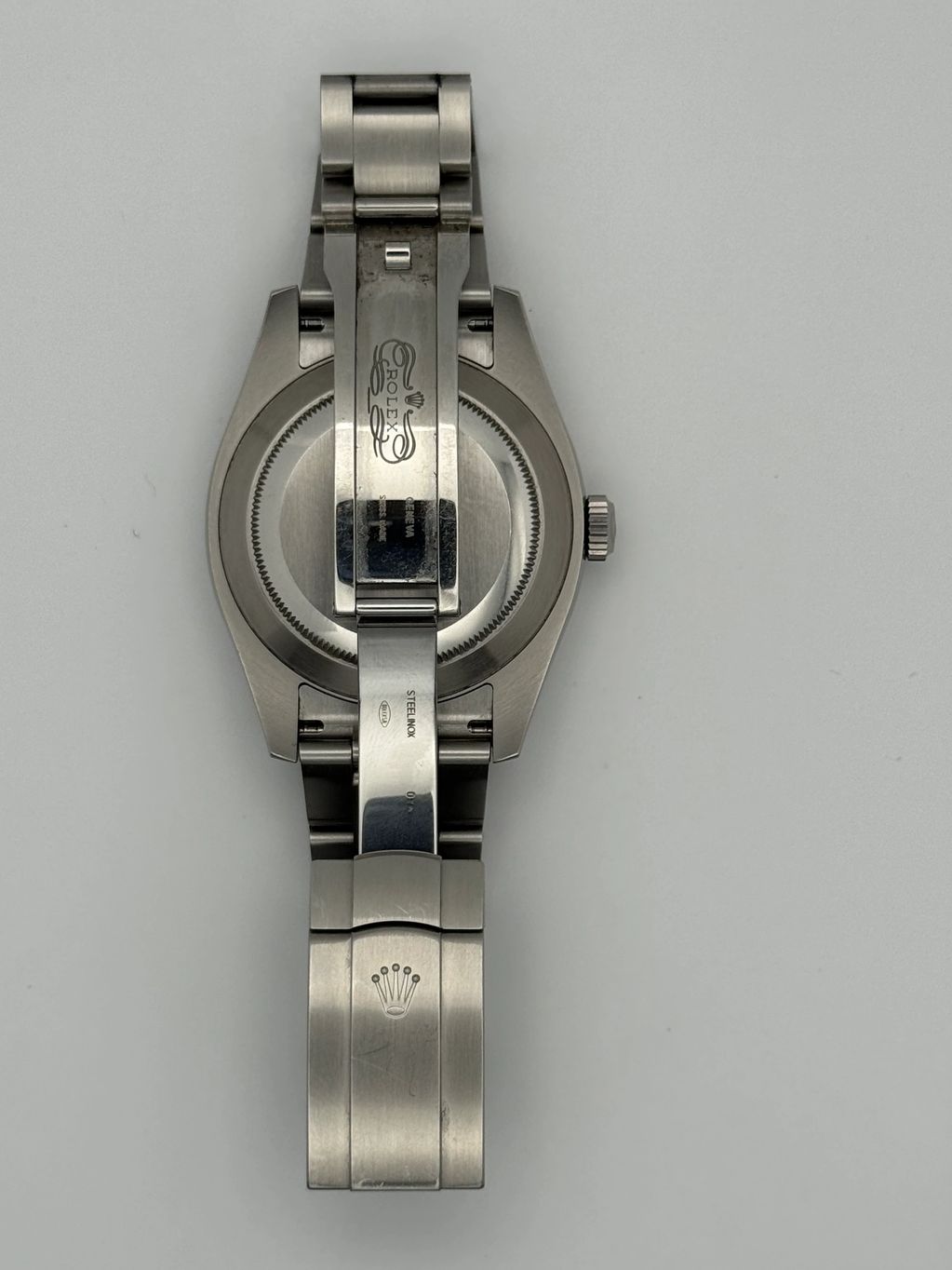 Back view of a stainless steel Rolex watch with an open clasp.