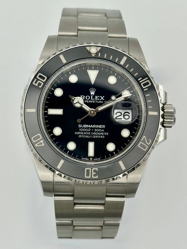 Rolex Submariner wristwatch with black dial and silver bracelet.
