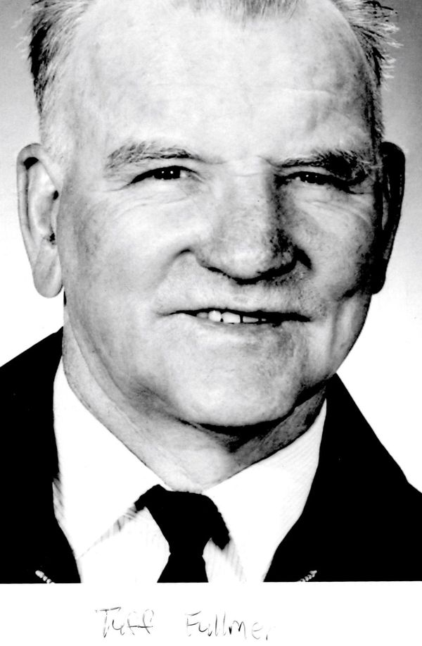 Black-and-white portrait of an older man in a suit and tie.