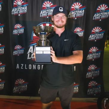 Man holding a trophy at Arizona Long Drive event.