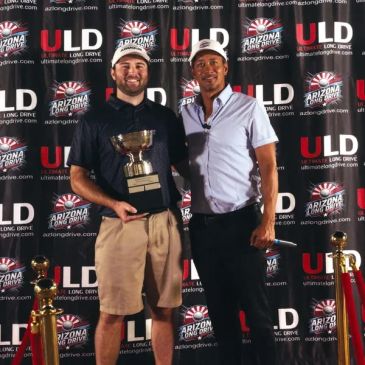 Two men posing with a trophy at Arizona Long Drive event.