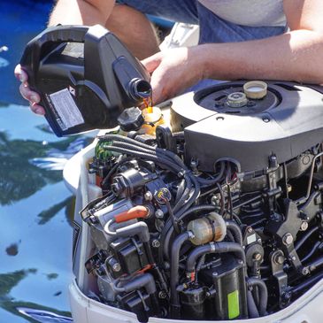 Man changing oil on an outboard 4-stroke