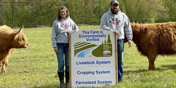 Environmentally Verified farmers with highland cows