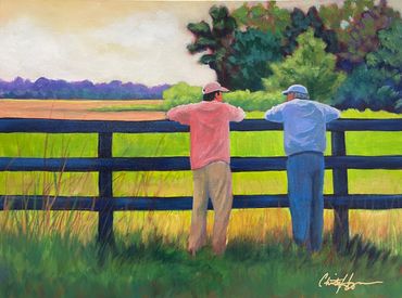 two men leaning on a fence, with colorful landscape in background