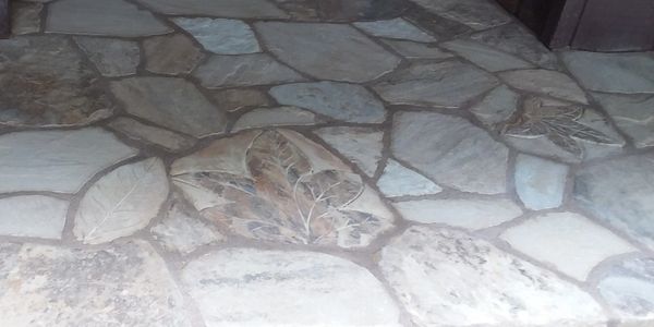 Carved leaves in the stone, bring character to the entry patio.