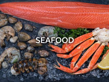 Fresh seafood assortment on ice with salmon, crab legs, shrimp, and clams.