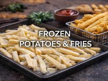 Frozen French fries on a baking tray with cooked fries in a basket.