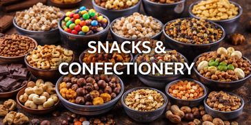 Assortment of snacks and confectionery in bowls on a rustic surface.