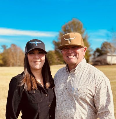 Couple wearing GRAB'EM BY THE HORNS baseball cap