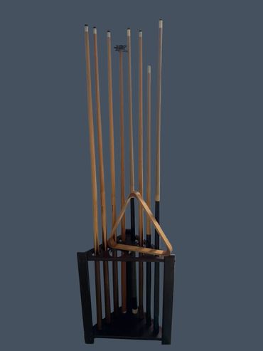 Set of pool cues arranged in a black wooden rack.