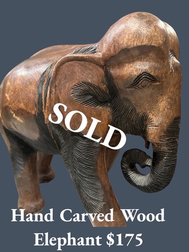 Hand-carved wooden elephant sculpture priced at $175.