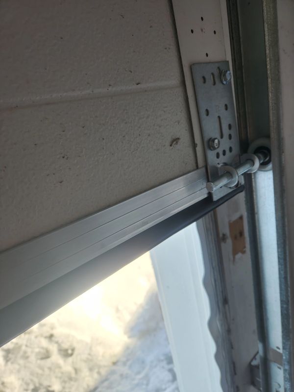 Garage door repair in Ottawa — bottom seal, retainer, cables, brackets, rollers in Barrhaven