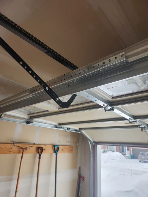 Garage door panel repair — reinforcement to cracked panel in Kanata