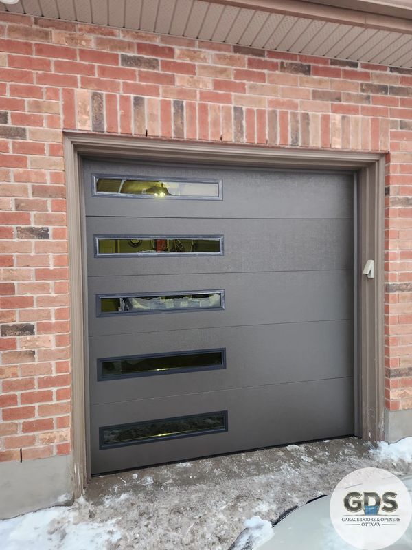 An old garage door was replaced to a new insulated garage door