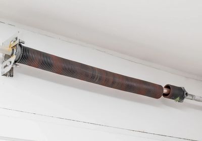 Garage door repair: broken garage door spring located above garage door