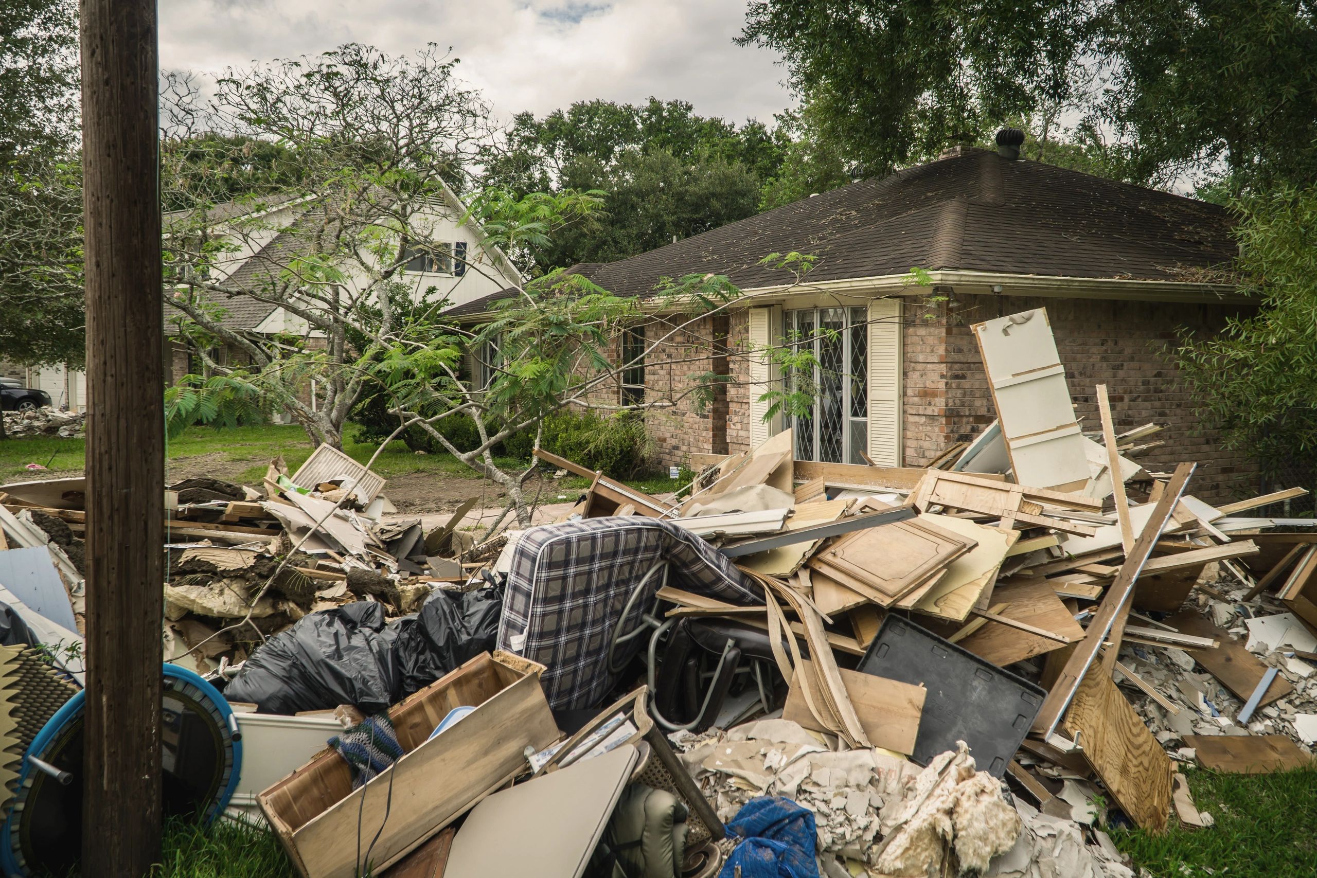 Flood ruined personal items and furniture piled outside a home after a major flood