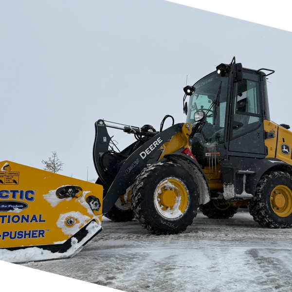 John Deere equipment clearing snow from a commercial lot. 