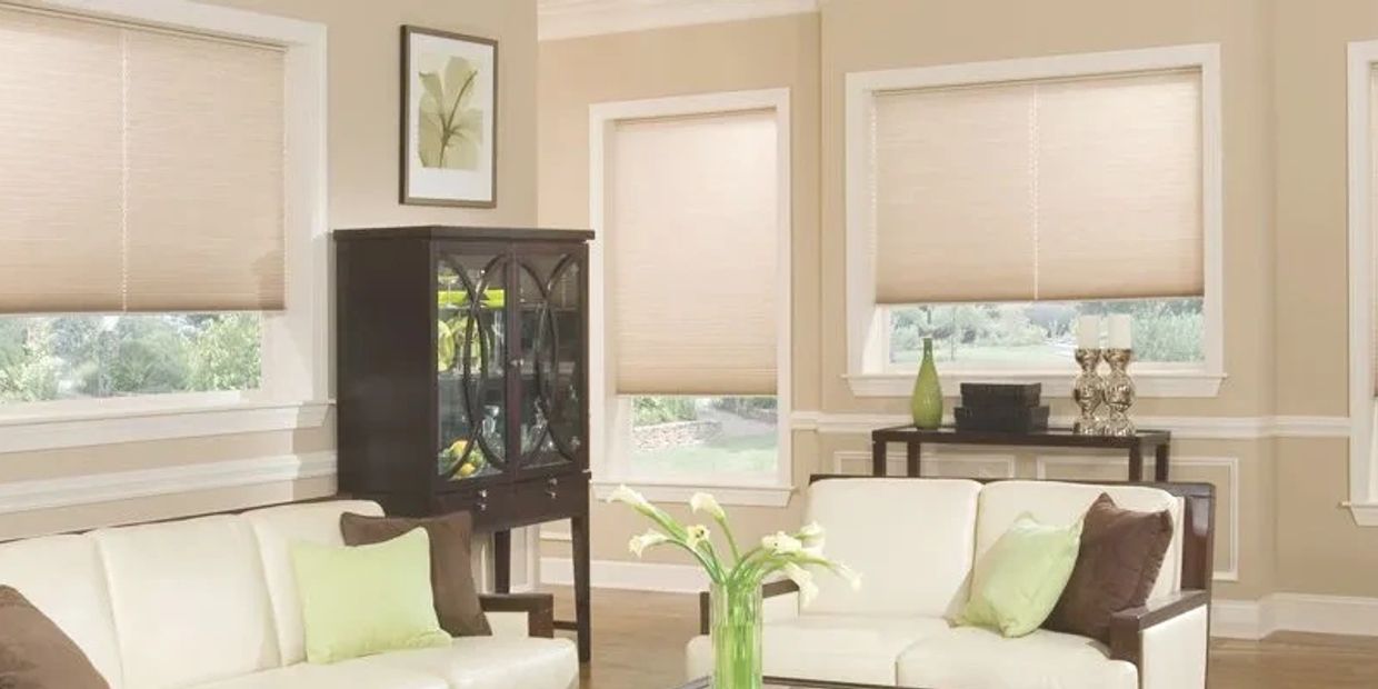 Cozy living room with beige walls and cream sofas.
