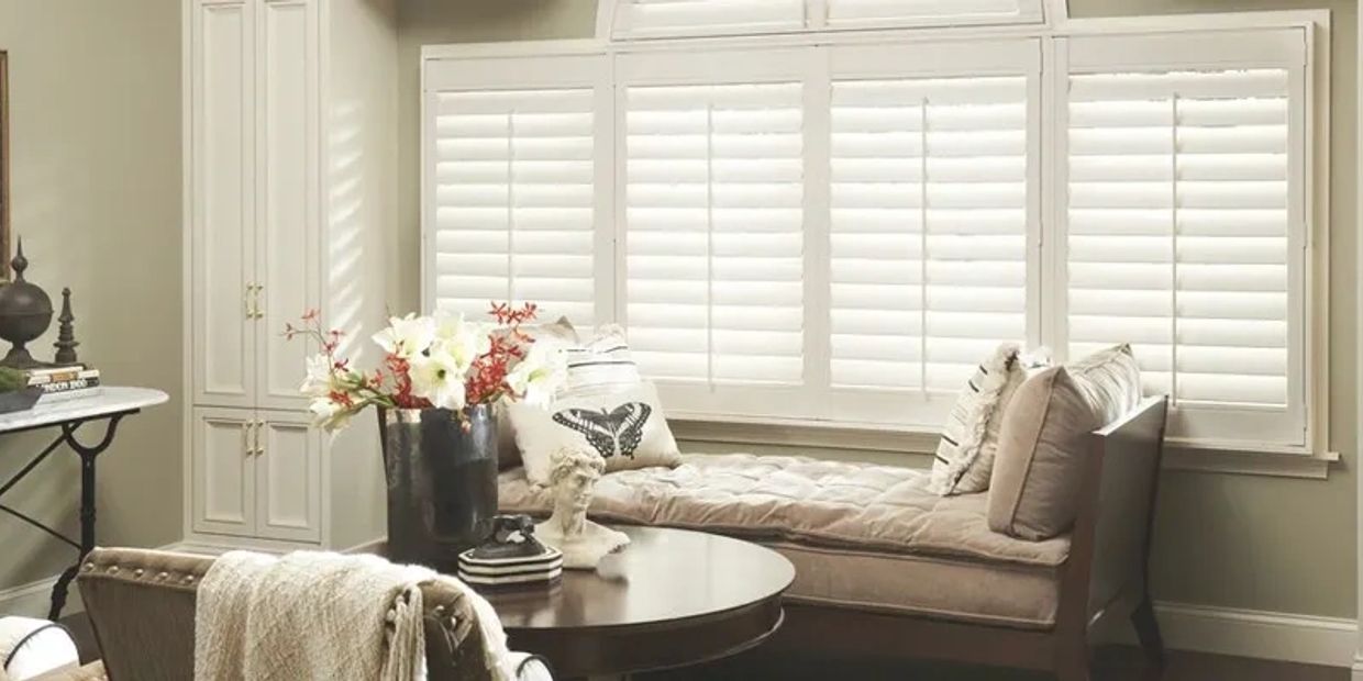 Cozy sitting area with beige chaise lounge and decorative pillows.