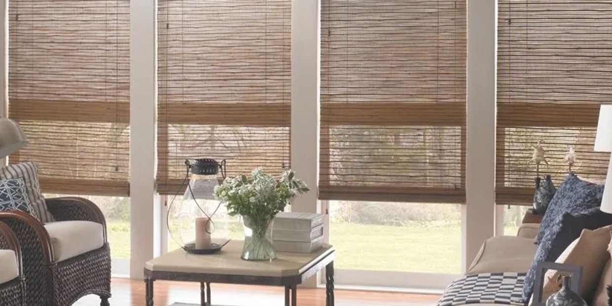 Cozy sunlit living room with bamboo blinds and floral decor.