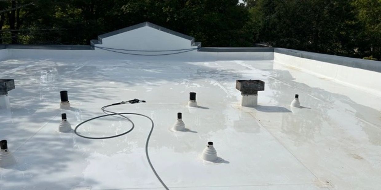 A clean white Rubber Roof with vents visible.