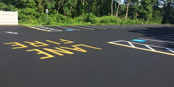 Commercial Parking Lot Sealcoating, hot tar crack filler , and line striping.